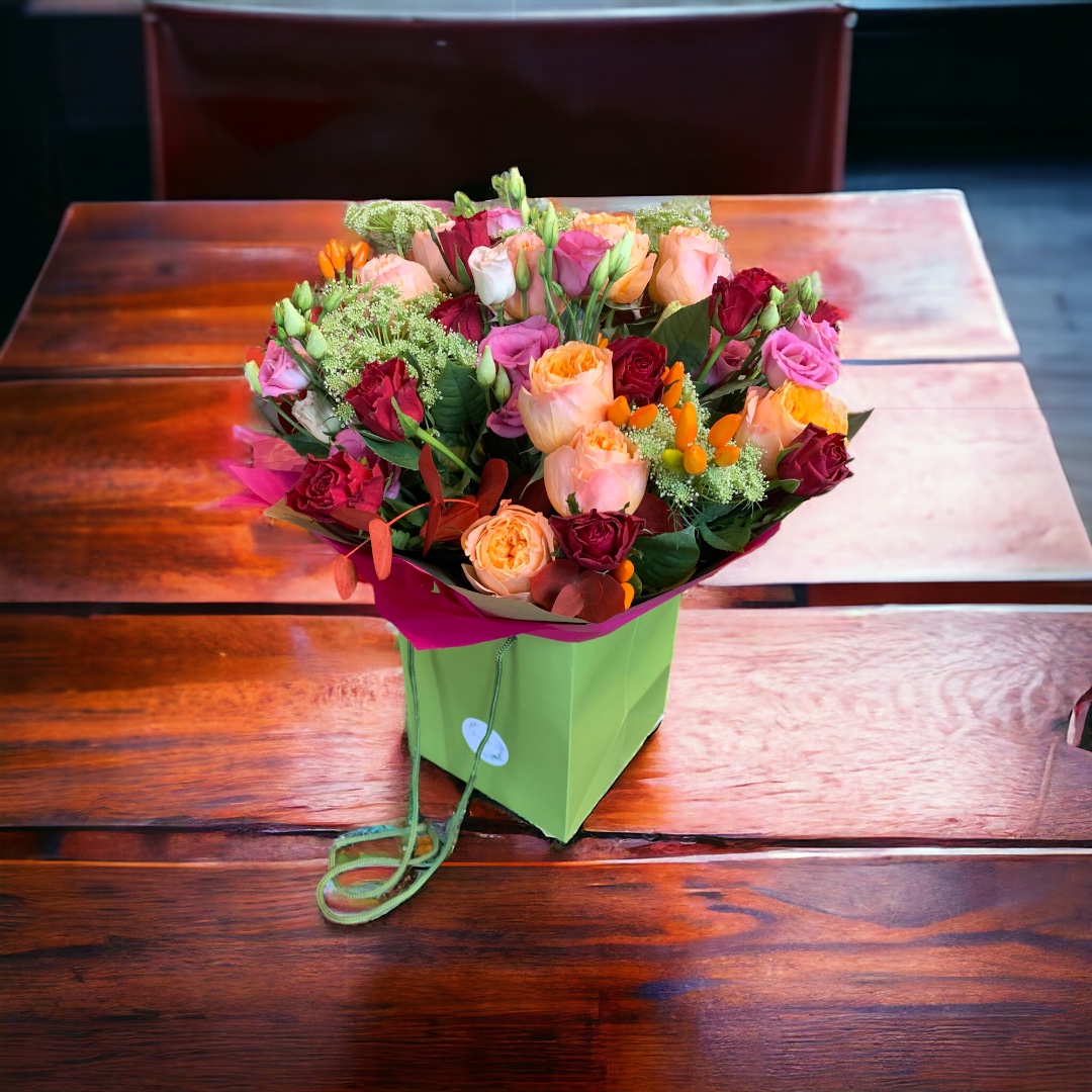 bouquet of colourful flowers on a dark wooden counter top